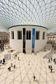 People in courtyard of British museum with glass roof on Great Russell street, London, UK