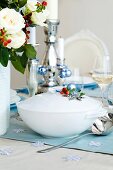 Christmas soup in porcelain tureen bowl decorated with baubles