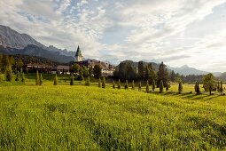 View of Hotel Schloss Elmau, meadows and mountain, Upper Bavaria, Germany