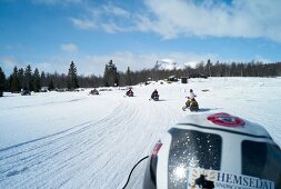 People riding snow mobile on snow at Hemsedal ski resort in Norway