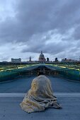 Rear view of man on Millennium Bridge, Tate Modern and St Paul's Cathedral at London, UK