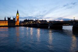 View of Houses of Parliament at Westminster, Big Ben and river Thames at dusk, London, UK