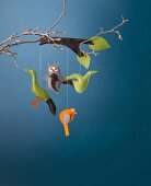 Mobile birds hanging on branches