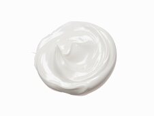 Blob of sunscreen cream on white background
