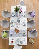 Dining table decorated brightly with cutlery and tableware
