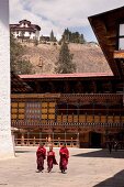 Children walking in Paro Dzong courtyard in Bhutan