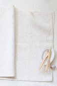 Wooden forks, wooden skewers and kitchen twine on a linen cloth