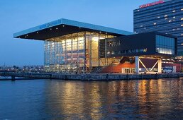 View of Muziekgebouw aan 't IJ on IJ river at dawn, Amsterdam, Netherlands