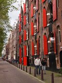 Row of houses with red shutters in Prinsengracht, Amsterdam, Netherlands