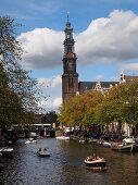 View of Westerkerk church and boats in Prinsengracht canal, Amsterdam, Netherlands