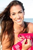 Laughing brunette woman with tanned skin