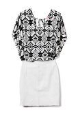 Patterned black and white blouse with leather mini skirt on white background
