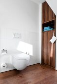 Bathroom with fitted wardrobe and toilet seat with wooden floor