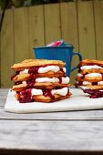 Waffles with cream and cranberry on table