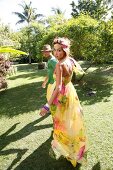 Couple wearing colourful summer outfit having fun in garden