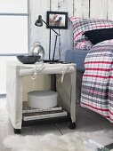 Cloth cabinet with casters, metal shelf lamp and alarm clock