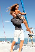 Portrait of young couple having fun on yacht, smiling