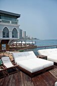 Beach chairs with cushions by the sea at La Plage Beach Club, Beirut, Lebanon