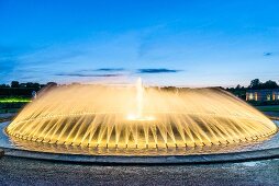 Woman in front of fountains at Royal Gardens in Herrenhausen Palace, Hannover, Germany