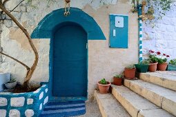 Entrance with blue door in alley at Safed, Israel