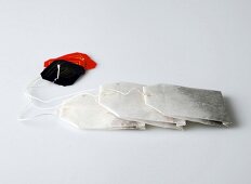 Three tea bags on white background