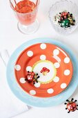 Polka dot plate with ladybug figurines as table setting