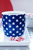 Cup with star decoration on plate with sweets