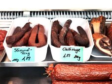 Variety of horse sausages in containers at Pferdemetzgerei Worle Kaspar in Munich, Germany