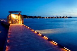 Illuminated dock huts on Dhigufinolhu island, Maldives