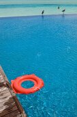 Red rubber ring at pool in Dhigufinolhu island resort, Maldives