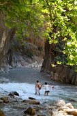 Couple walking in water in national park, Saklikent, Aegean, Turkey