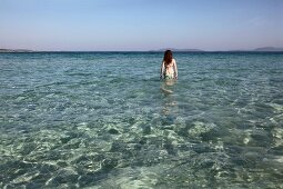 Man lying on Altinkum beach in Alacati, Cesme Peninsula, Turkey