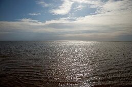 View of horizon on water and clouds in sky at Fano Beach, Denmark