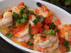 Garlic prawns in serving dish at restaurant, overhead view