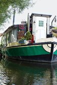 Moored house boat with terrace and entrance door