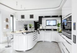View of kitchen in white with rounded walls and fancy furniture
