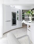 View of kitchen with rounded walls, fancy furniture and wine cooler