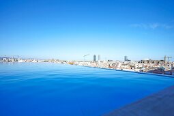 View of cityscape with Infinity Pool and Grand Hotel Central in Barcelona, Spain