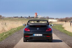 Person driving black convertible car, Schleswig-Holstein, Germany