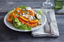 Pumpkin wedges with Camembert on a bed of lettuce