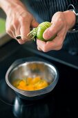 Close-up of man peeling lime