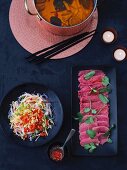 Chinese fondue, beef and a glass noodle salad