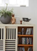 A sideboard used for storing CDs with slatted sliding doors