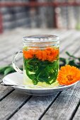 Herbal tea with marigolds and verbena in a tea glass