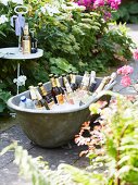 Party drinks in an old zinc bath tub filled with ice in a garden