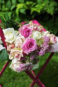 A bunch of roses on a garden chair