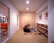 Mann und Kind im Spielzimmer auf Tatamimatten