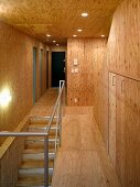 Staircase and hallway with wood paneling and ceiling