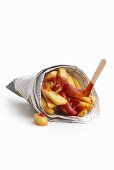 Chips with ketchup wrapped in newspaper