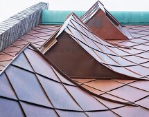 Reclaimed dormer windows on a roof with sheet metal cladding